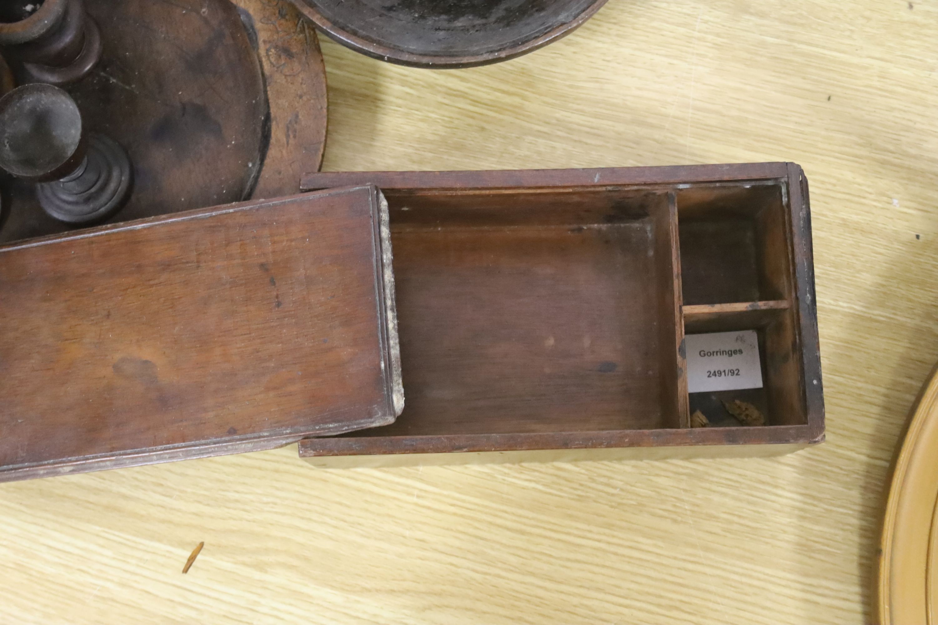 A group of assorted treen including an 18th century sliding lid mahogany box, a candle stand and various goblets etc.